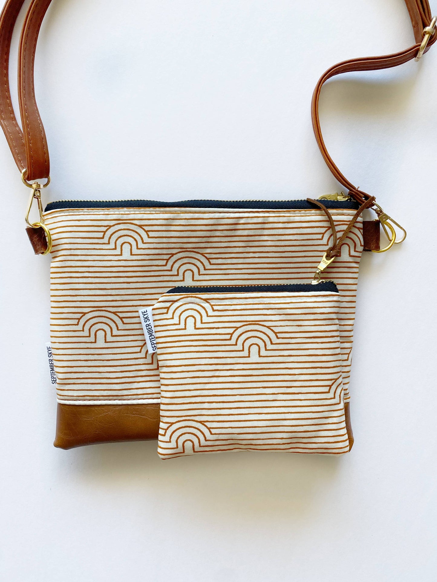 Small crossbody bag in linear caves saddle